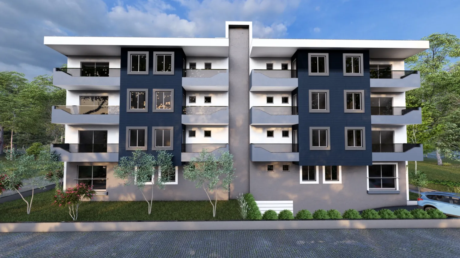 Simetrik lacivert cephe panelleri, balkonları ve zemin kat boyunca uzanan peyzaj düzenlemesiyle modern apartman yapısının ön cephe görünümü.