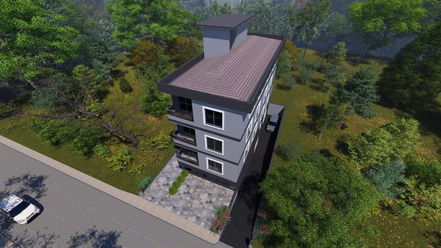 Aerial view of the Small House project showing its roof, balconies, stone-paved forecourt and dense green surroundings.