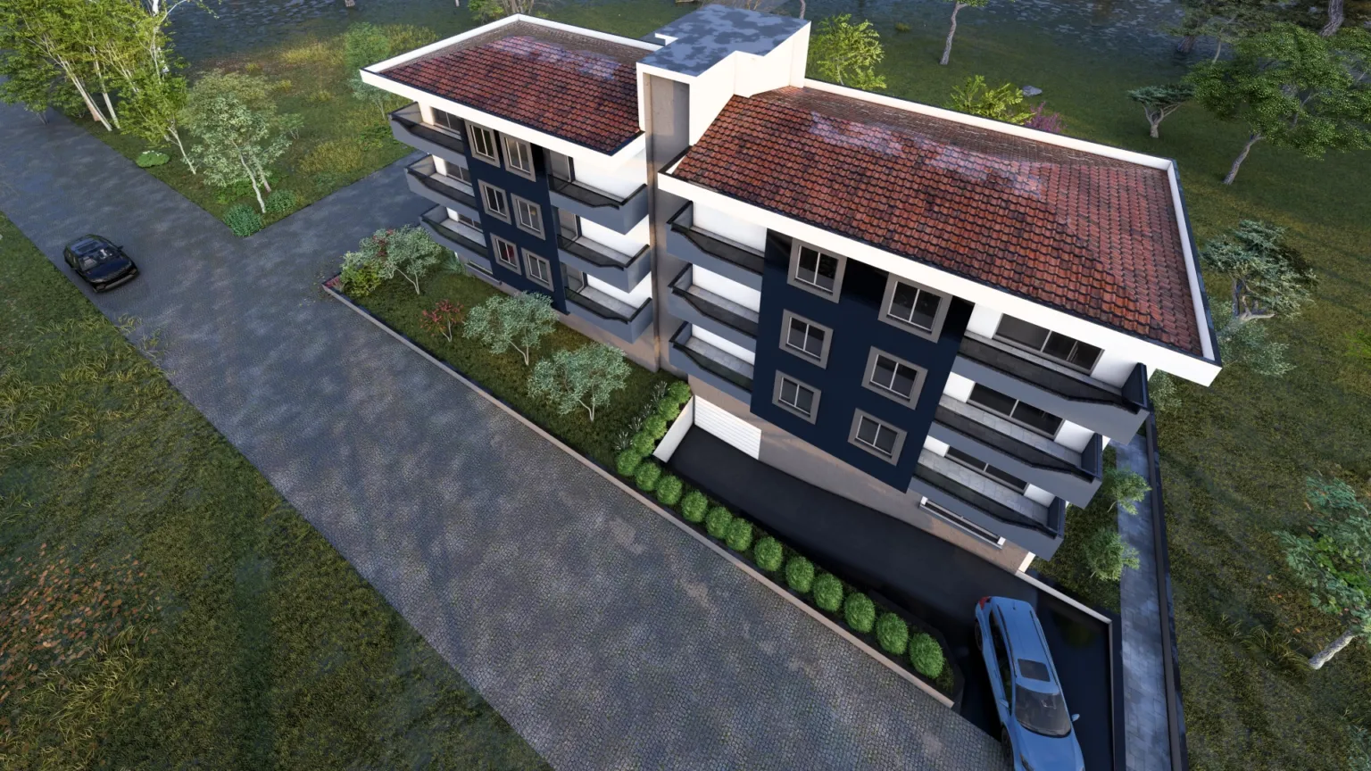 Oblique aerial rendering of a modern apartment building with red tiled roofs, navy façade panels, rows of balconies, landscaped planting, and surrounding streets.